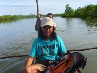 Sylviane Taking a pirogue to reach the study site