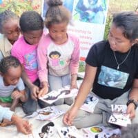 Kids learn how to play lemur card games with LCN volunteer, Misa.