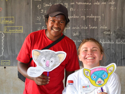 Our science communications volunteer, Coral Chell, shares lemur masks with VOI staff and children in Mariarano.