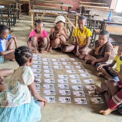 TFM-kids-cardgames Children at a school supported by Teach for Madagascar play our Lemurs card game.